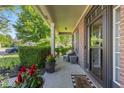 Inviting front porch with comfortable seating, potted plants, and a 'You're Here' welcome mat at 1783 Trillium Ct, Avon, IN 46123