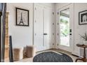 Bright foyer with a glass front door, light floors, decorative rug, and contemporary decor at 2036 Central Ave, Indianapolis, IN 46202