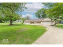 Lovely single-story home with a well-kept lawn and a long driveway at 212 W Banta Rd, Indianapolis, IN 46217