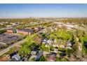 Aerial view of a neighborhood, buildings, mature trees, and a cityscape in the distance at 2221 Station St, Indianapolis, IN 46218