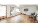 Cozy living room with natural light, hardwood floors, and a view of the front yard at 2319 E 40Th St, Anderson, IN 46013