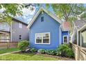 Attractive exterior showcasing the home's blue siding, landscaping, and classic architectural details at 253 E Minnesota St, Indianapolis, IN 46225