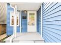 Welcoming porch showcasing details like the door, siding, and front entry details at 253 E Minnesota St, Indianapolis, IN 46225
