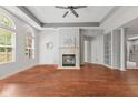 Bright living room featuring tray ceiling, modern fireplace, neutral color palette, and rich hardwood floors at 2726 Reflection Way, Greenwood, IN 46143