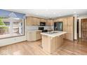 Well-lit kitchen with wooden cabinets, stainless steel appliances, and an island at 320 Thornberry Dr, Carmel, IN 46032