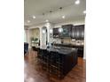 Spacious kitchen features a large island with seating and modern pendant lighting at 3243 Red Fox Trl, Columbus, IN 47201