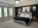 Beautiful bedroom boasts lots of natural light and tray ceiling with modern light fixture at 3243 Red Fox Trl, Columbus, IN 47201