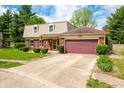 Charming two-story home with brick and vinyl siding, an attached garage, and a well-manicured lawn at 3505 Autumn Ct, Columbus, IN 47203