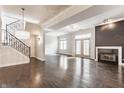 Bright open-concept living room featuring a fireplace, hardwood floors, staircase and ample natural light at 355 E Ohio St # 314, Indianapolis, IN 46204