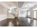 Bright open-concept living room featuring a hardwood floors, staircase and ample natural light at 355 E Ohio St # 314, Indianapolis, IN 46204