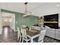 Dining area with elegant lighting and a view into the cozy living room at 4032 Stubbington Ln, Indianapolis, IN 46239