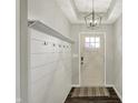 Welcoming entryway features a coat rack and stylish light fixture at 4032 Stubbington Ln, Indianapolis, IN 46239