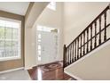 Bright and airy foyer with staircase, hardwood floors, and natural light at 4602 Amesbury Pl, Westfield, IN 46062