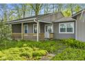 Charming porch with wooden railings and trim, leading to the main entrance of the home at 5039 Five Points Rd, Indianapolis, IN 46239