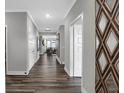 Inviting hallway with hardwood floors, neutral paint, and stylish decorative mirror at 5062 Foxley Park Ln, Avon, IN 46123