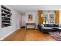 Living room with hardwood floors, a gray sectional sofa and modern decor at 5439 Indianola Ave, Indianapolis, IN 46220