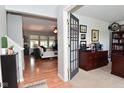 Warm entryway showcasing an office with a view into the spacious living room and hardwood floors at 5507 Wakefield Rd, Greenwood, IN 46142