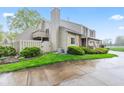 Attractive townhome with beige siding, stone details, and a private rear balcony and gated yard at 582 Conner Creek Dr, Fishers, IN 46038