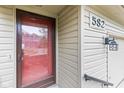 Close up of the front door with address number, exterior light fixture, and a storm door at 582 Conner Creek Dr, Fishers, IN 46038