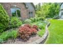 Beautiful landscaping with colorful plants surrounding the well maintained home at 5851 Beisinger Pl, Indianapolis, IN 46237