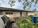 Exterior shot of the back of the house, featuring access doors, greenery, and lawn at 593 S 10Th S St, Noblesville, IN 46060