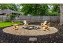 Cozy backyard firepit area with Adirondack chairs, perfect for outdoor relaxation and entertaining at 6137 Evanston Ave, Indianapolis, IN 46220