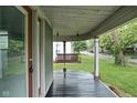Inviting front porch featuring a porch swing and painted wood flooring at 6159 Broadway St, Indianapolis, IN 46220
