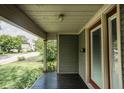Covered front porch with a painted wood floor and view of the neighborhood at 6159 Broadway St, Indianapolis, IN 46220
