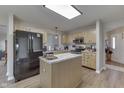 Well-lit kitchen featuring stainless steel appliances, a kitchen island, and a stylish subway tile backsplash at 6503 E Walton Dr, Camby, IN 46113