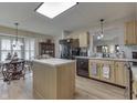 Bright kitchen featuring an island, black appliances and eat-in dining area adjacent to the kitchen at 6503 E Walton Dr, Camby, IN 46113