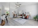 Bright and airy living room featuring vaulted ceilings, light gray walls, wood floors, and modern decor at 6613 Apollo Way, Indianapolis, IN 46278