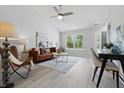 Inviting living room with abundant natural light, stylish furniture, and a vaulted ceiling with ceiling fan at 6613 Apollo Way, Indianapolis, IN 46278