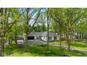 Aerial view of a charming home with a well-kept lawn, surrounded by mature trees at 6673 Karyn Dr, Avon, IN 46123