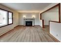 Spacious living room featuring a stone fireplace, large window, and wood-look flooring at 6985 E County 100 S Rd, Avon, IN 46123