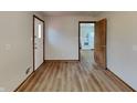 Open living room with wood-look flooring flowing into the kitchen at 6985 E County 100 S Rd, Avon, IN 46123