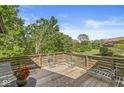 Spacious outdoor deck with multiple seating arrangements and scenic views overlooking a large manicured lawn at 8047 Van Ness Way, Indianapolis, IN 46240
