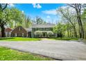 Beautiful two-story home exterior, lush lawn, mature trees, and scenic surroundings at 8820 Mud Creek Rd, Indianapolis, IN 46256