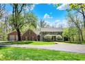 Beautifully landscaped home exterior, featuring a well-manicured lawn and a detached garage at 8820 Mud Creek Rd, Indianapolis, IN 46256