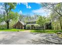 Charming exterior view of a two-story home, lush lawn, and mature trees at 8820 Mud Creek Rd, Indianapolis, IN 46256