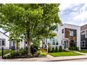 A beautiful two-story home with a lush green lawn and mature trees at 952 Elm St, Indianapolis, IN 46203