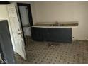 Small kitchen area with minimal black cabinets and a sink at 1014 W 33Rd St, Indianapolis, IN 46208