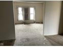 Living room area with a view of three windows, showing torn carpet and dirty space at 1014 W 33Rd St, Indianapolis, IN 46208