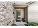 Front door of home featuring neutral siding and brick, small garden bed, and an entryway at 10143 Winslow Way, Fishers, IN 46037