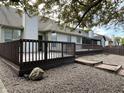Spacious backyard featuring a large wooden deck and low-maintenance gravel ground cover at 10305 Lakeland Dr, Fishers, IN 46037
