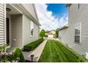 View down the side yard of a home, showing the well-maintained lawn and partial view of the backyard at 1041 Lincoln Park E Dr, Greenwood, IN 46142