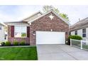 Charming single-Gathering home with a brick facade, attached two-car garage and well-manicured lawn at 1041 Lincoln Park E Dr, Greenwood, IN 46142