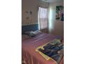 Cozy bedroom with a pink bed and a window that allows natural light, creating a comfortable space at 10425 Candy Apple Ln, Indianapolis, IN 46235