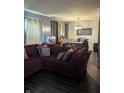 Inviting living room featuring a large sectional sofa, hardwood floors, and ample space for dining at 10425 Candy Apple Ln, Indianapolis, IN 46235