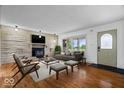 Cozy living room with hardwood floors, comfortable seating, and a decorative fireplace at 10456 N State Rd 267, Brownsburg, IN 46112