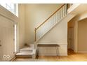 Welcoming entryway with staircase, hardwood floors, and wainscoting detail at 12253 Bedrock Ct, Fishers, IN 46037